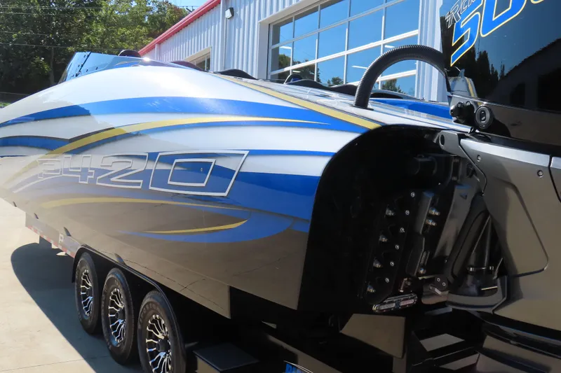 Slide: The Image of 2025 Performance Powerboats P420 with sleek blue and yellow design on trailer. - 28