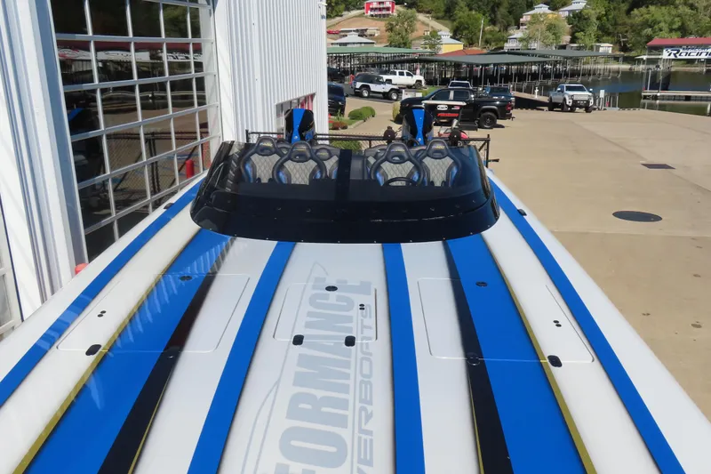 Slide: The Image of 2025 Performance Powerboats P420 with sleek blue and white design at a marina. - 3