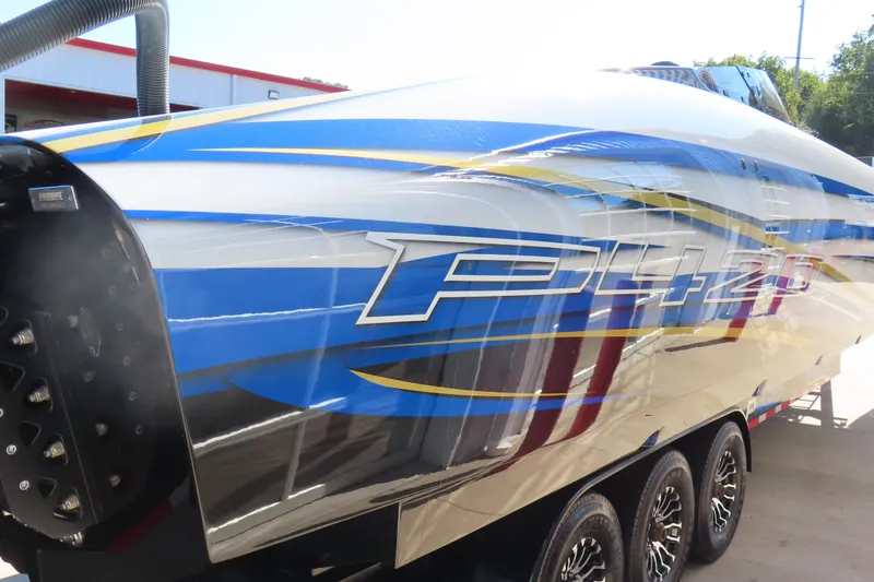 Slide: The Image of 2025 Performance Powerboats P420 with vibrant blue and yellow design on trailer. - 31