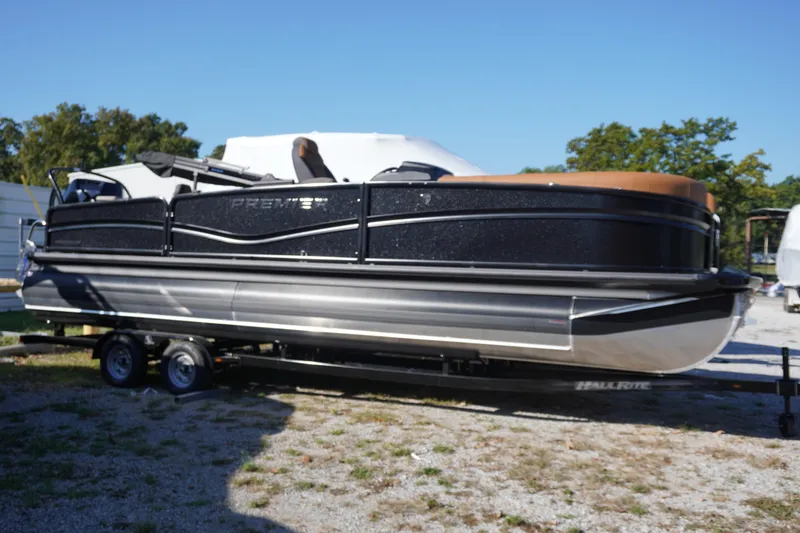 The Image of 2026 Premier 250 Solaris RS pontoon boat displayed outside a store for sale. - 0