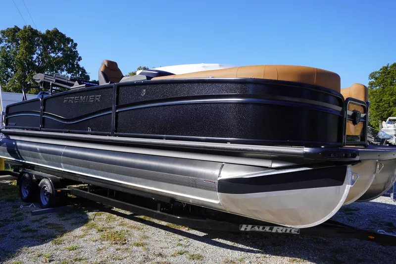 Slide: The Image of 2026 Premier 250 Solaris RS pontoon boat on trailer, black and tan design. - 1