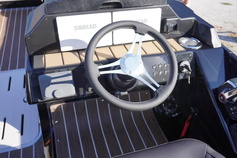 Slide: The Image of Luxurious seating on 2026 Premier 250 Solaris RS boat, featuring tan and black upholstery. - 10