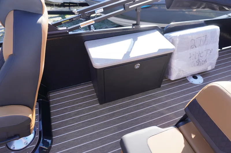 Slide: The Image of 2026 Premier 250 Solaris RS boat interior with cup holders and storage drawer. - 18