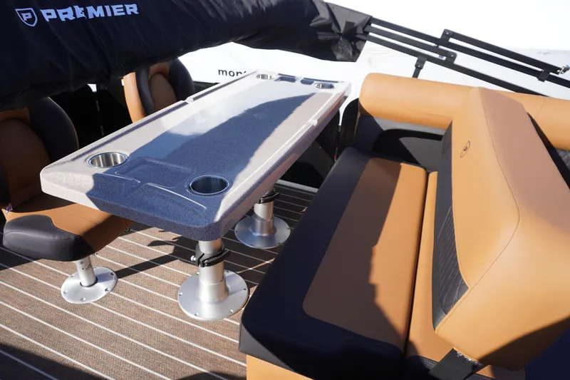 Slide: The Image of 2026 Premier 250 Solaris RS boat interior with tan and black seating, outdoor setting. - 21