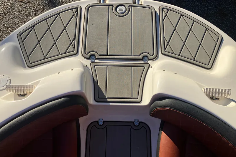 Slide: The Image of 2000 Chaparral Sunesta 232 boat deck with cushioned seating and textured flooring. - 18