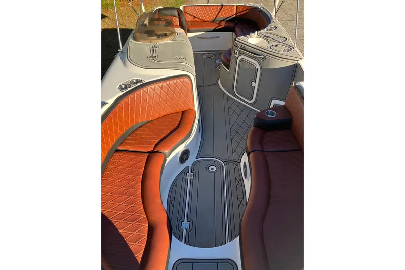 Slide: The Image of 2000 Chaparral Sunesta 232 boat interior with brown leather seating and sleek design. - 20