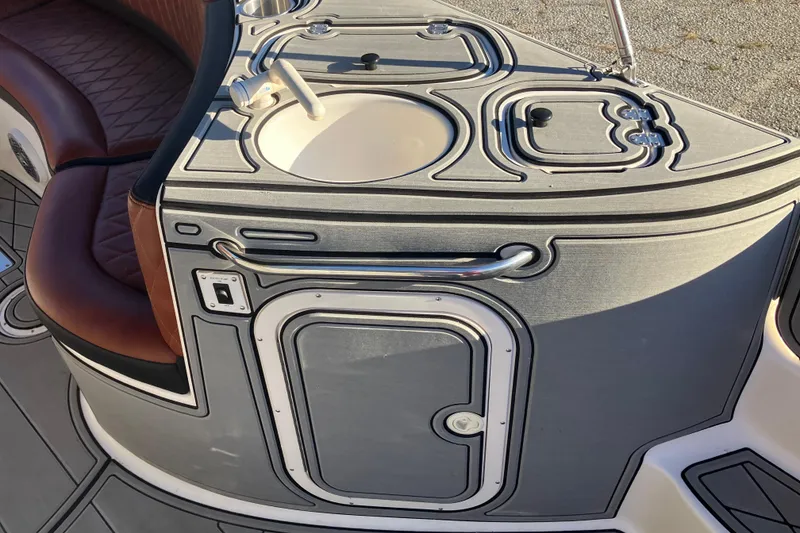 Slide: The Image of 2000 Chaparral Sunesta 232 boat interior with sink and seating area. - 21