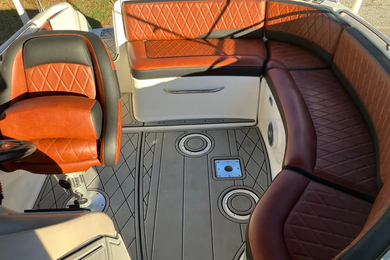 Slide: The Image of 2000 Chaparral Sunesta 232 boat interior with brown leather seating and modern design. - 22