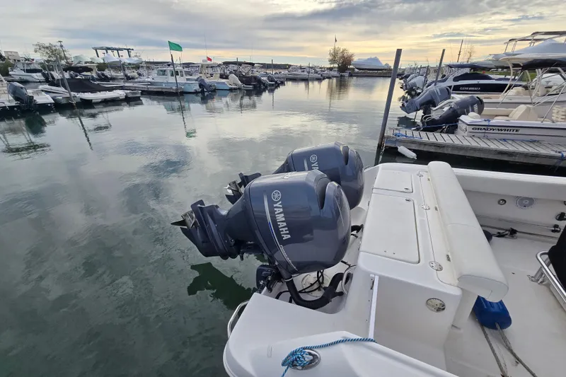 Slide: The Image of 2014 Robalo R240 Center Console with Yamaha engines docked at marina. - 11