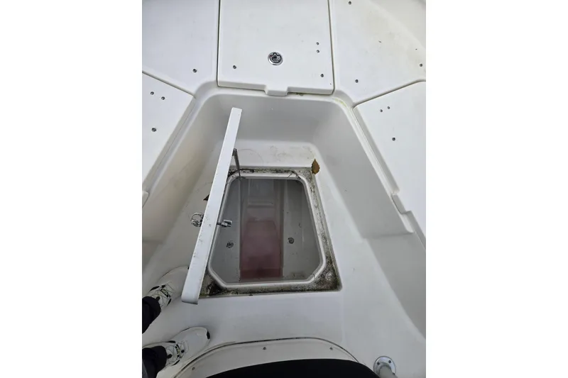Slide: The Image of 2014 Robalo R240 Center Console boat with open storage compartment. - 8
