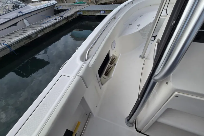 Slide: The Image of 2014 Robalo R240 Center Console boat docked at marina, showcasing interior details. - 9
