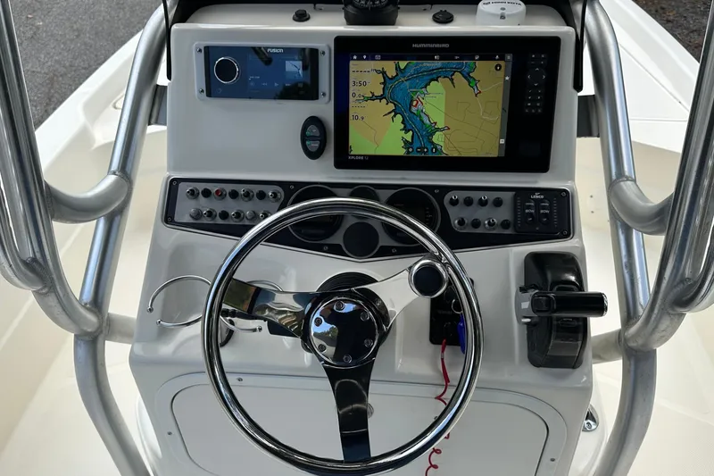 Slide: The Image of 2013 Skeeter SX240 boat console with navigation system and steering wheel. - 12