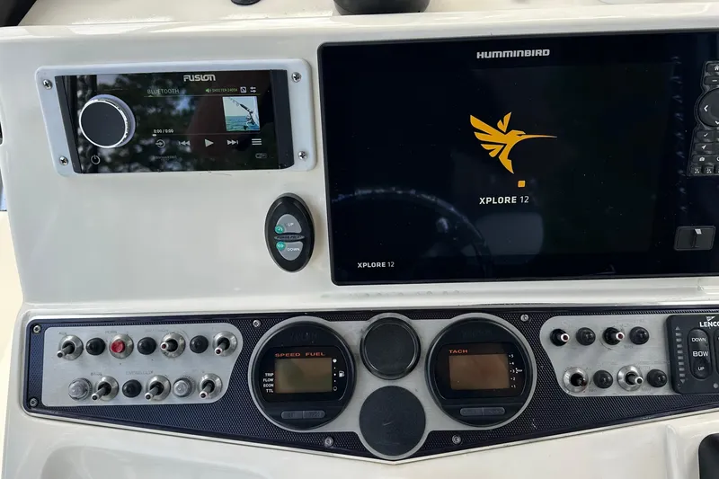 Slide: The Image of Control panel of a 2013 Skeeter SX240 boat with Humminbird Xplore 12 display. - 13