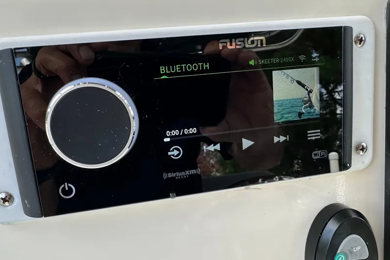 Slide: The Image of Fusion stereo system on 2013 Skeeter SX240 boat displaying Bluetooth connectivity. - 14