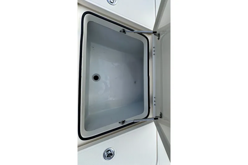 Slide: The Image of Open storage compartment on a 2013 Skeeter SX240 boat. - 17