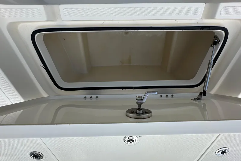 Slide: The Image of Open storage compartment on a 2013 Skeeter SX240 boat. - 18