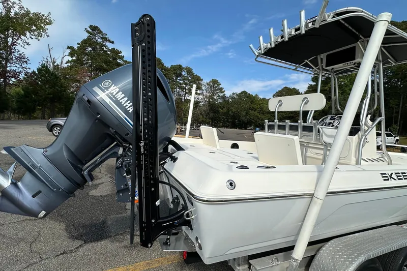 Slide: The Image of 2013 Skeeter SX240 boat with Yamaha outboard motor, parked on a trailer. - 3