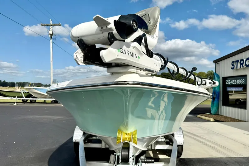 Slide: The Image of 2026 Key West 210 Bay Reef boat with Garmin equipment, parked outdoors under a blue sky. - 10