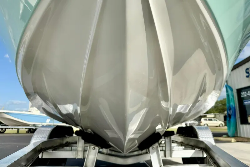 Slide: The Image of 2026 Key West 210 Bay Reef boat hull on trailer, showcasing sleek design. - 11