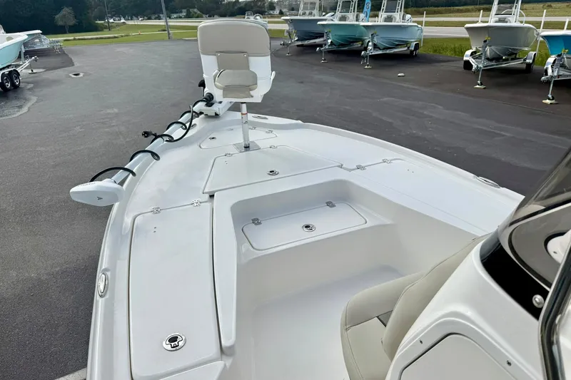 Slide: The Image of 2026 Key West 210 Bay Reef boat interior with seating and storage compartments. - 12