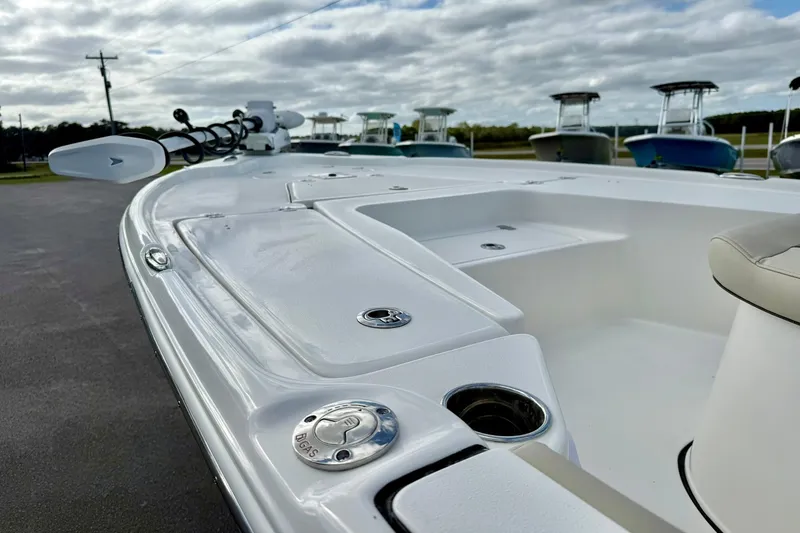 Slide: The Image of 2026 Key West 210 Bay Reef boat deck with gas cap and seating, under cloudy sky. - 14