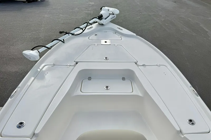 Slide: The Image of 2026 Key West 210 Bay Reef boat deck with storage compartments and trolling motor. - 16