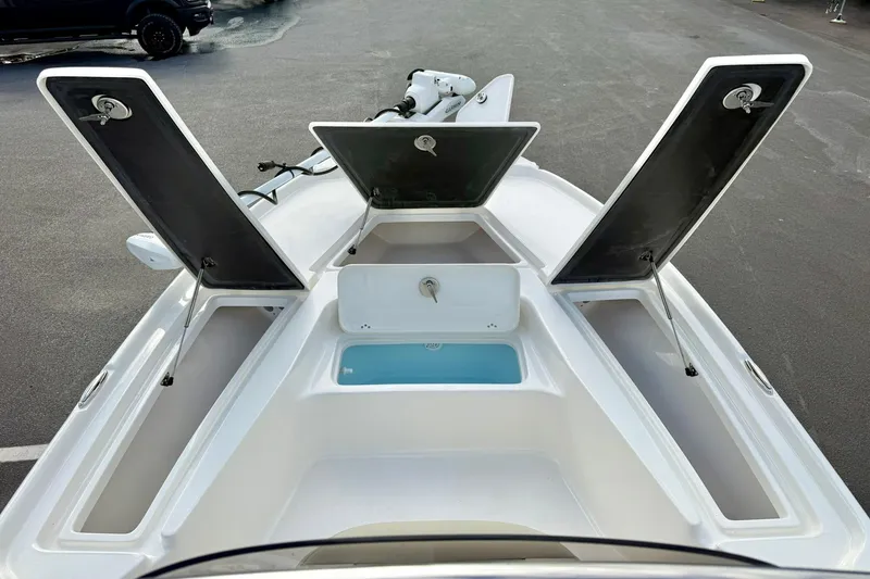 Slide: The Image of 2026 Key West 210 Bay Reef boat with open storage compartments and livewell. - 17