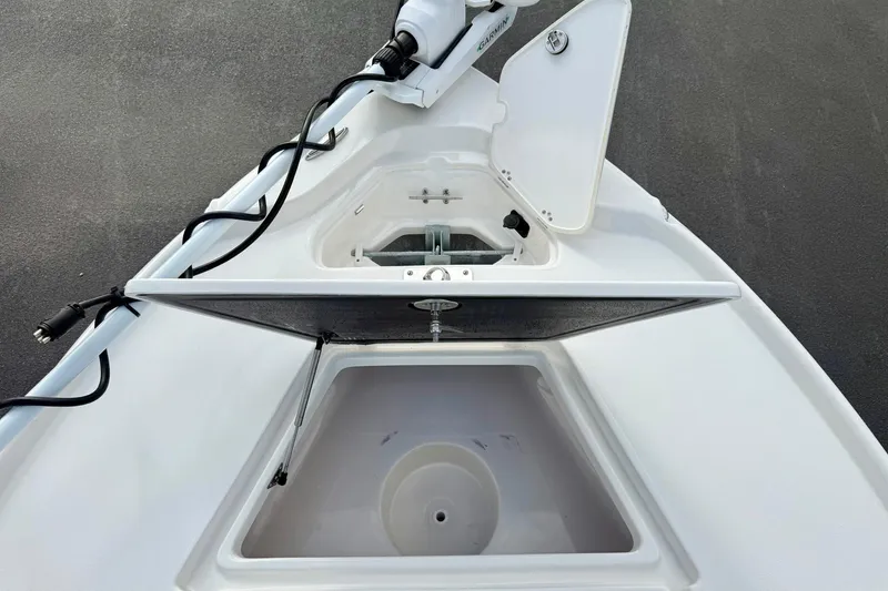 Slide: The Image of 2026 Key West 210 Bay Reef boat deck with open storage compartments. - 18