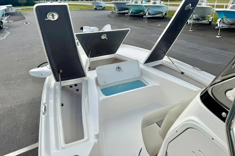 Slide: The Image of 2026 Key West 210 Bay Reef boat with open storage compartments and seating. - 25