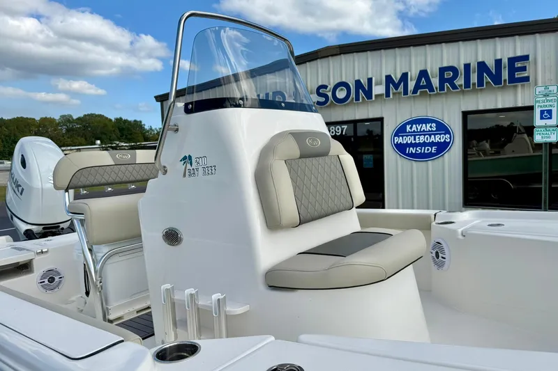 Slide: The Image of 2026 Key West 210 Bay Reef boat at a marine dealership, showcasing seating and console. - 29