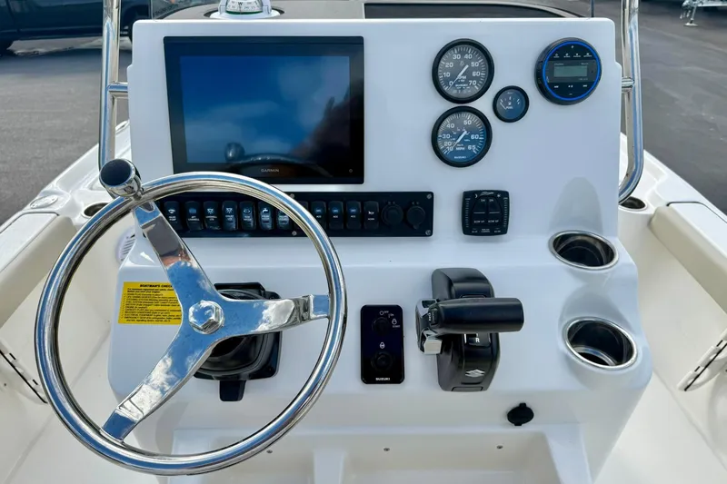 Slide: The Image of 2026 Key West 210 Bay Reef boat dashboard with steering wheel and control panel. - 3