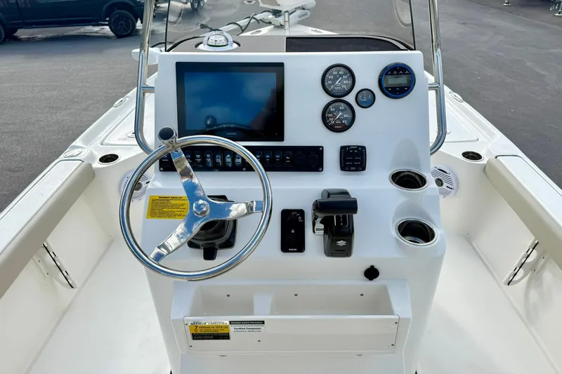 Slide: The Image of 2026 Key West 210 Bay Reef boat console with steering wheel and navigation controls. - 33