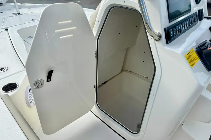 Slide: The Image of 2026 Key West 210 Bay Reef boat console storage compartment open. - 35
