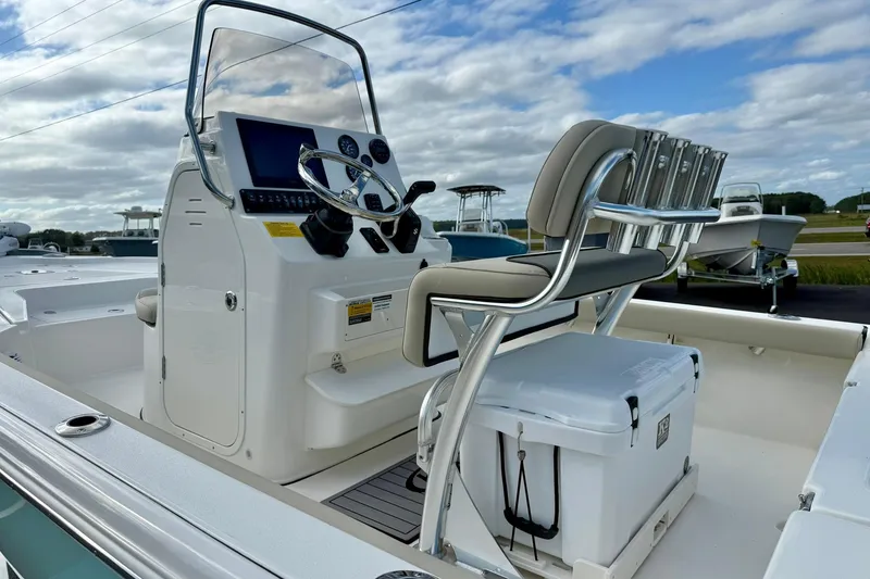 Slide: The Image of 2026 Key West 210 Bay Reef boat interior with steering console and seating. - 36