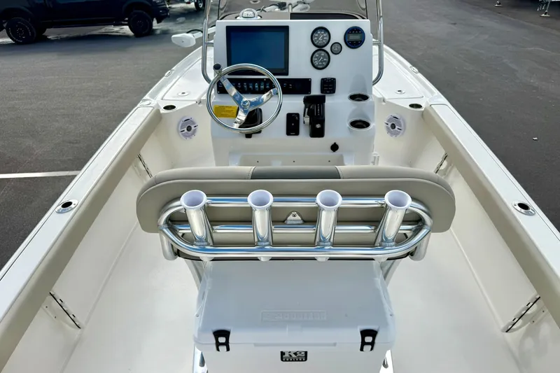 Slide: The Image of 2026 Key West 210 Bay Reef boat interior with steering console and rod holders. - 37