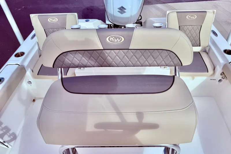 Slide: The Image of 2026 Key West 210 Bay Reef boat interior with cushioned seating and KW logo. - 41