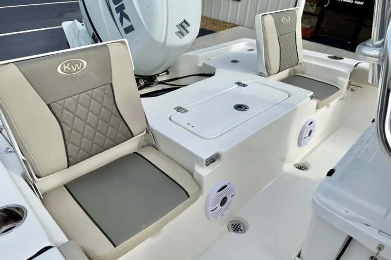 Slide: The Image of 2026 Key West 210 Bay Reef boat interior with cushioned seating and storage compartments. - 42
