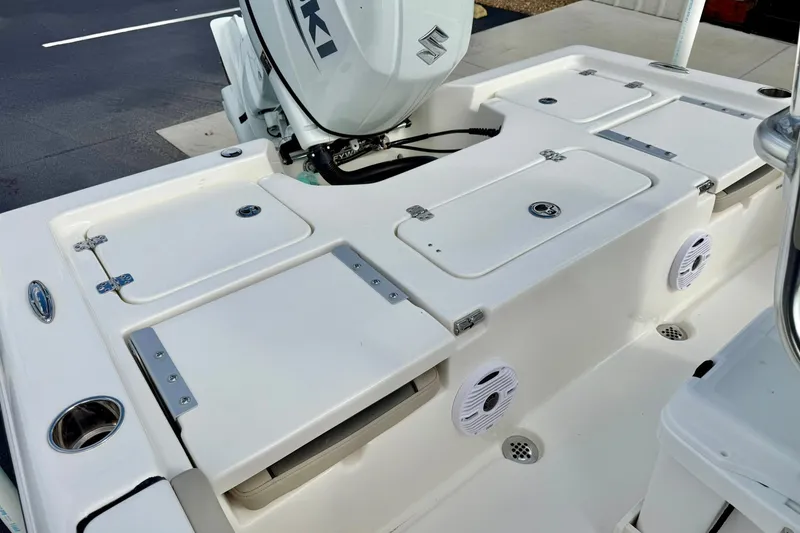 Slide: The Image of 2026 Key West 210 Bay Reef boat deck with storage compartments and Suzuki engine. - 43