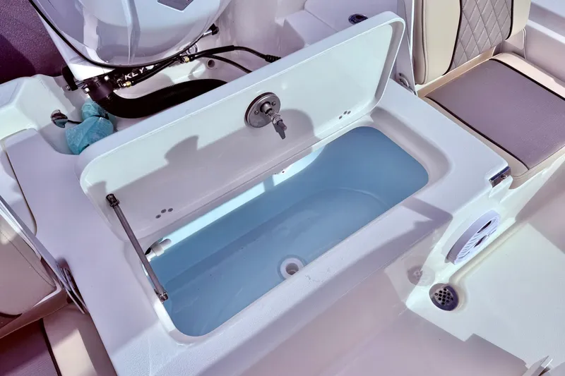 Slide: The Image of 2026 Key West 210 Bay Reef boat livewell with open lid and seating area. - 45