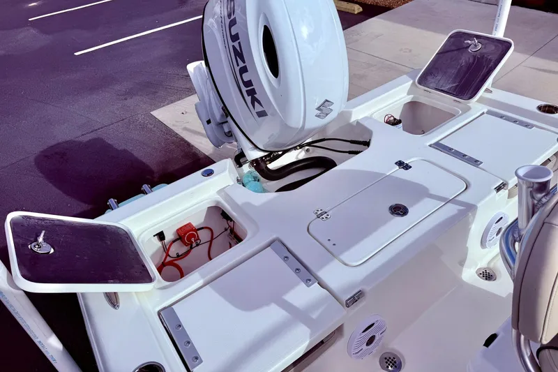 Slide: The Image of 2026 Key West 210 Bay Reef boat with Suzuki outboard motor and open storage compartments. - 46