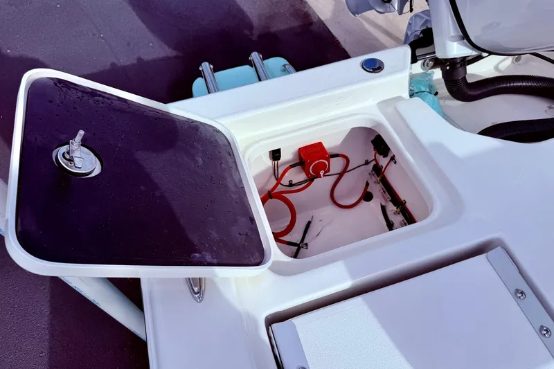 Slide: The Image of Open storage compartment on 2026 Key West 210 Bay Reef boat, showing wiring and components. - 47