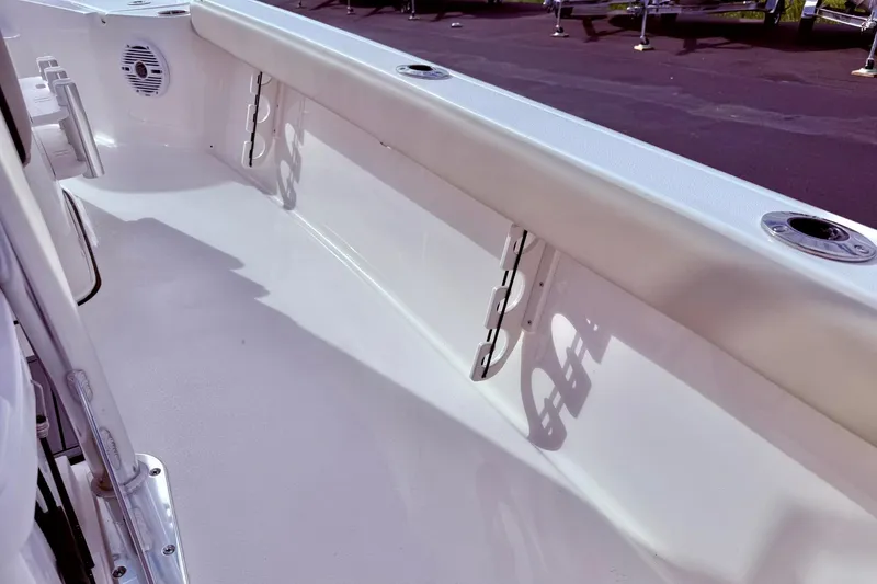 Slide: The Image of 2026 Key West 210 Bay Reef boat interior with rod holders and speaker. - 49