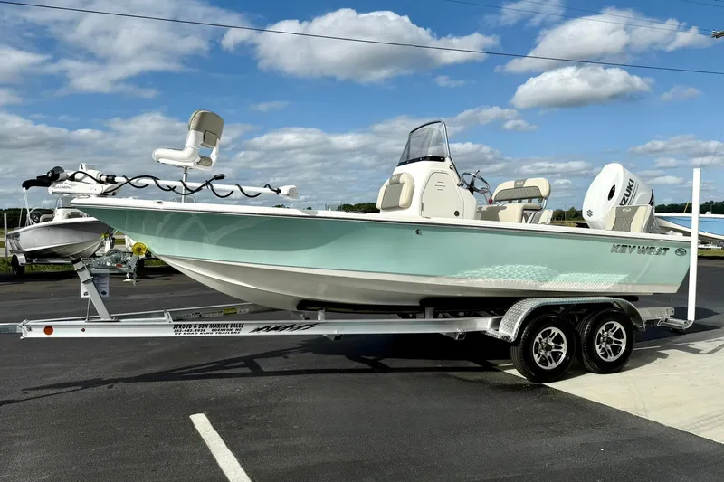 Slide: The Image of 2026 Key West 210 Bay Reef boat on trailer under blue sky. - 5
