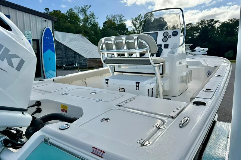 Slide: The Image of 2026 Key West 210 Bay Reef boat with Suzuki engine, docked near a building. - 52