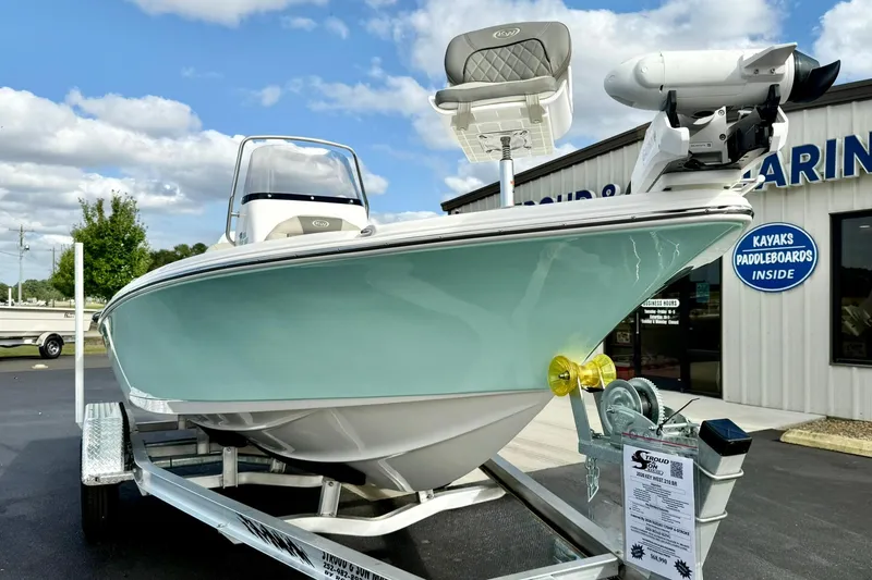 Slide: The Image of 2026 Key West 210 Bay Reef boat on trailer, displayed outside a marine store. - 9