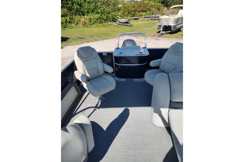 Slide: The Image of 2016 Starcraft CX 23 FD pontoon boat on trailer, parked outdoors under blue sky. - 3
