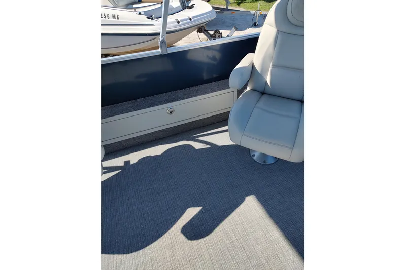 Slide: The Image of 2016 Starcraft CX 23 FD pontoon boat interior with beige seating and carpeted floor. - 4