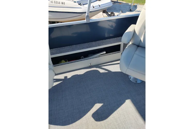 Slide: The Image of 2016 Starcraft CX 23 FD boat interior with two white captain chairs. - 5