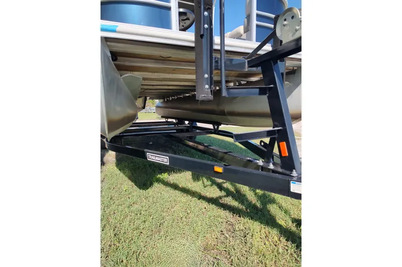 Slide: The Image of 2016 Starcraft CX 23 FD pontoon boat interior with plush seating and steering console. - 9