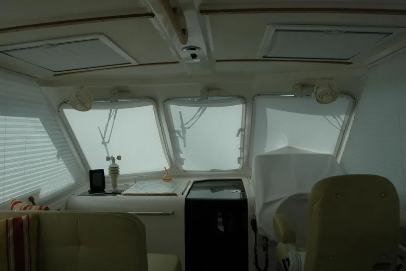 Slide: The Image of 2014 Back Cove 34 boat interior with helm, windows, and seating. - 100
